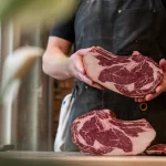 Chef holding beef meat